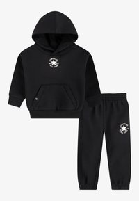 Black hoodie and sweatpants set made of soft fabric. Hoodie features a kangaroo pocket and a white logo. Pants have elastic cuffs and waistband.