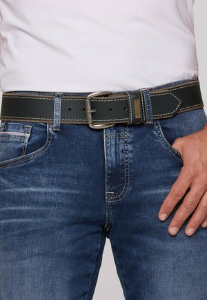 Black leather belt with a silver metal buckle, featuring contrasting beige stitching. Worn over blue denim jeans.