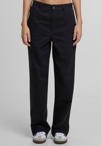 Wide-leg trousers in dark navy fabric with a textured finish, featuring front pockets and a centered button closure.