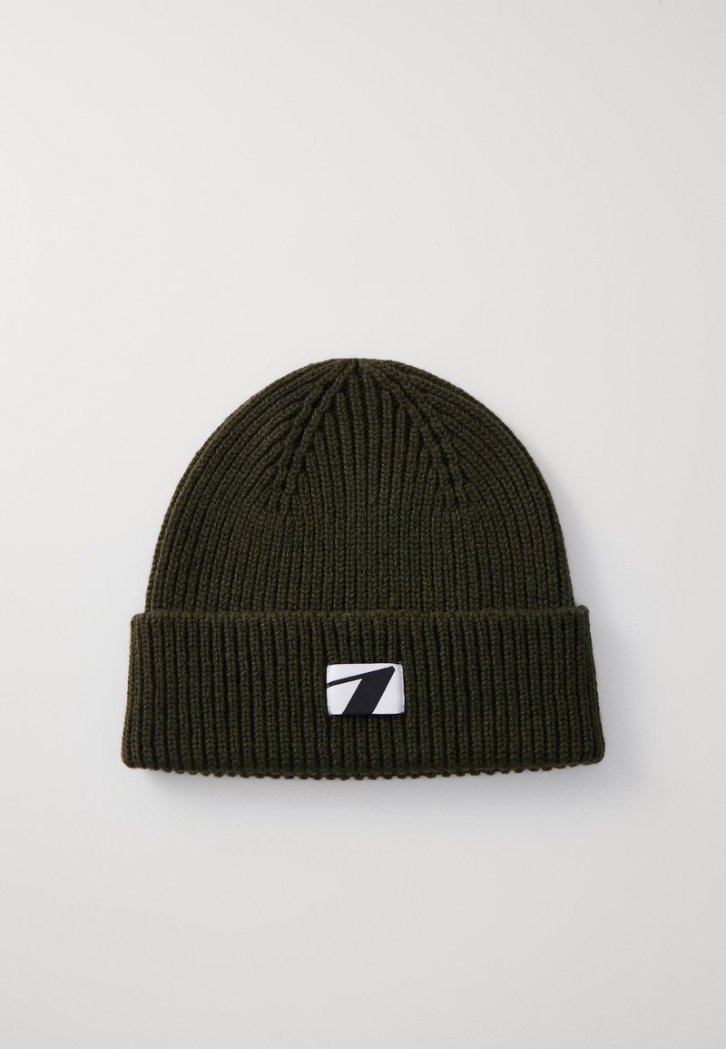Olive green ribbed knit beanie with a folded cuff and a patch featuring a stylized white number seven on a black background.