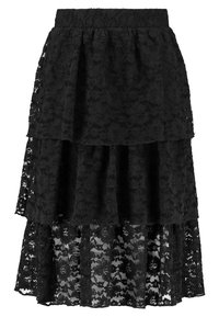 Jupe en dentelle noire avec un design en couches, comportant trois volants superposés. Texture douce avec des détails en motif floral. Taille élastique.