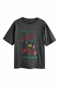 Dark gray t-shirt with a loose fit. Features a colorful, sequined graphic that reads "Santa's Spicy Mary" and includes decorative elements.