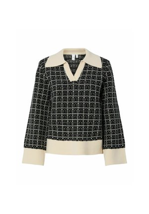 Svart og hvit mønstret genser med v-hals og kremfarget krage. Strikket tekstur, lange ermer og ribbet kant.