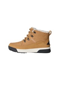 Tan ankle boots with a textured leather upper, fleece lining, round laces, and a rubber outsole featuring a black and white design.