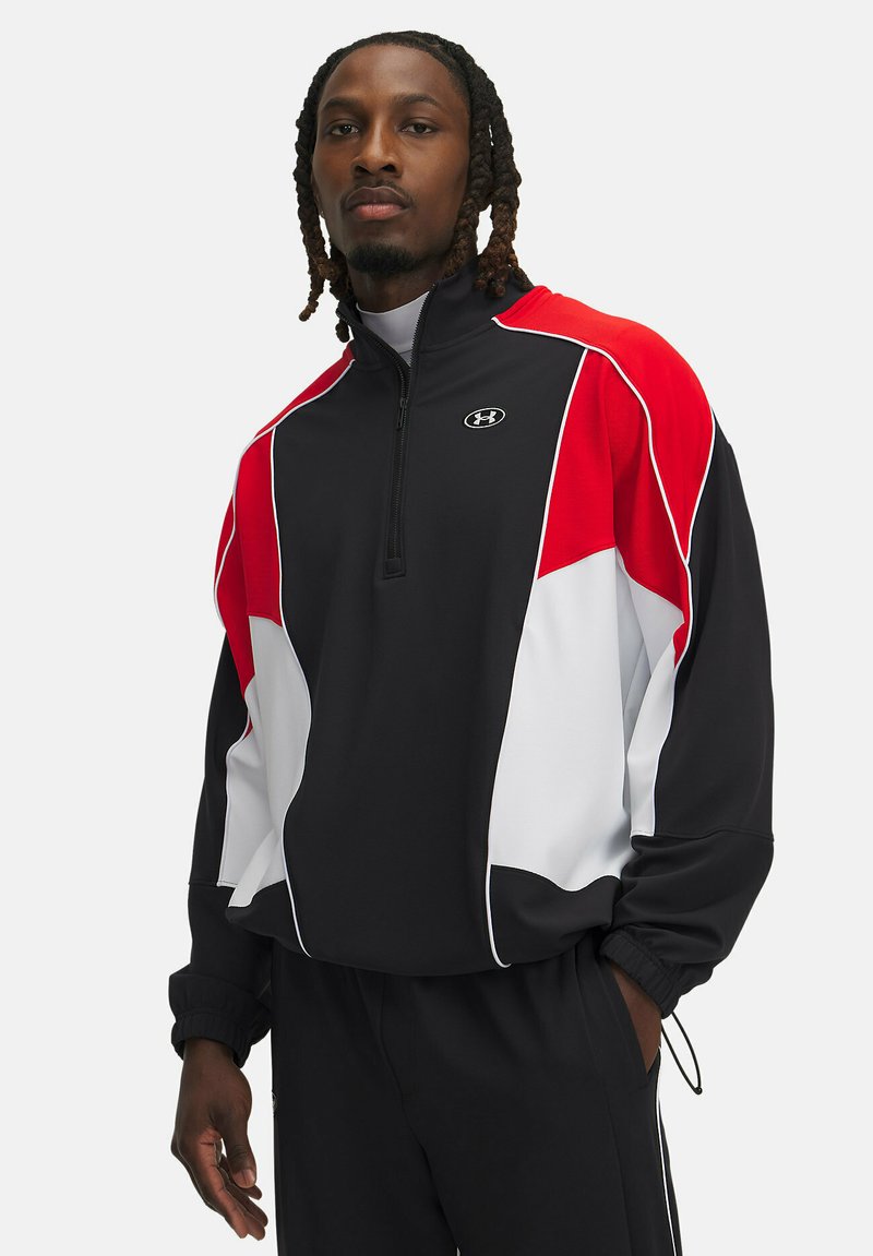 Sort og rød zip-up atletisk jakke med hvide detaljer, der har en høj krave og tekstureret stof. Under Armour-logoet er præsenteret tydeligt.
