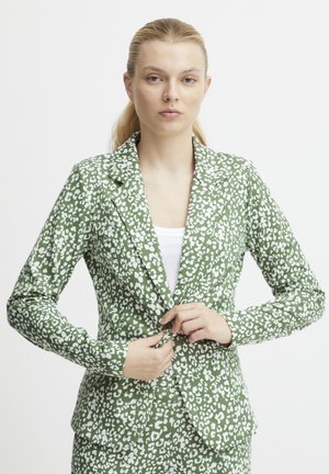 Green blazer with a white leopard print pattern. Features notched lapels and a single button closure. Fabric has a smooth texture.