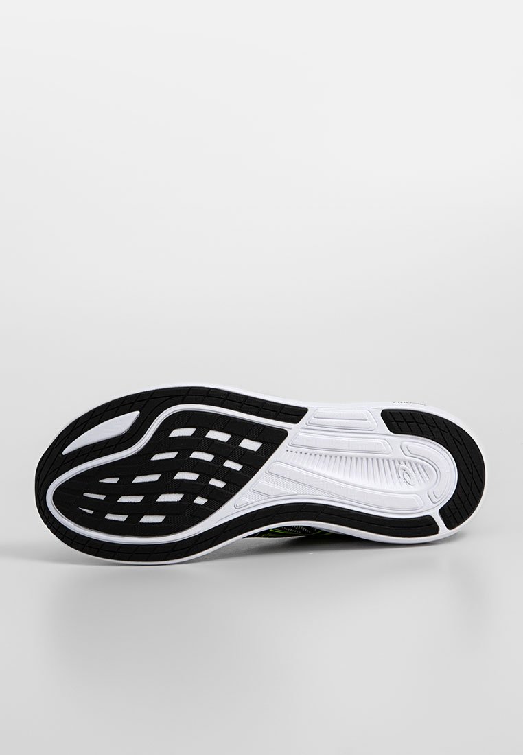 Suela de zapatilla de correr en blanco y negro con un diseño ondulado, que presenta goma texturizada para un mejor agarre y una entresuela con patrón para mayor amortiguación.