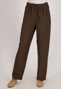 Bruine, lichte, wijde broek met een elastische tailleband en een trekkoord. Textuurstof met een gladde uitstraling.