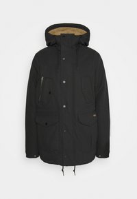 Black jacket with a zipper and button closure, multiple front pockets, drawstring at the hem, and a tan, textured inner lining.