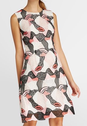 Robe blanche sans manches avec des motifs abstraits noirs, roses et corail comprenant des lèvres et des détails texturés semblables à de la dentelle.