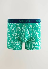 Boxers verts ornés d'un motif de feuilles et d'oiseaux, avec une taille élastique bleu marine affichant le nom de la marque "NEXT."