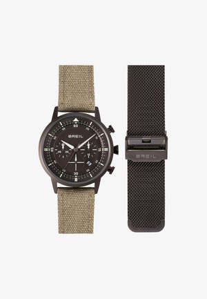 BREIL kronografur med sort urskive og beige strop i stof, plus en ekstra sort metal mesh-strop med lås.