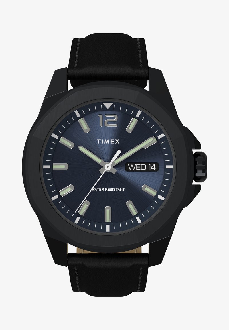 Must ja analogkell ümmarguse näo, sinise tekstuuri diali, helendavate tunni märkide, kuupäeva kuvamise ja musta nahkrihmaga; veekindel.