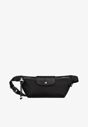 Black nylon belt bag with a textured black flap, silver hardware, logo printed strap, and adjustable strap for secure fit.