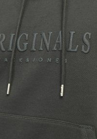 Dark green hoodie featuring raised "ORIGINALS" text, durable fabric, flat drawstrings, and metallic aglets. Smooth texture, casual design.