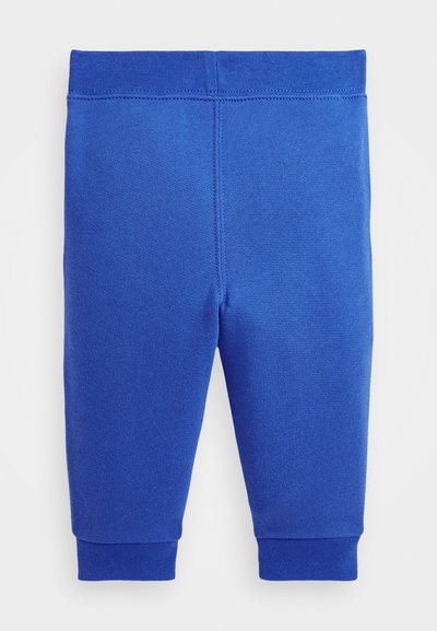 Blaue Baumwollleggings mit schmalem Schnitt, elastischem Bund und gerippten Bündchen an den Knöcheln. Glatte Textur ohne Muster.