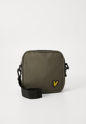 Olive green rectangular crossbody bag made of textured fabric, featuring a yellow embroidered logo, black strap, and zip closure.
