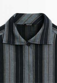 Collared shirt with vertical black and gray stripes, single black button near the collar, and "Massimo Dutti Made in Portugal" label inside.