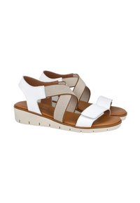 Sandalias cruzadas en blanco y beige con un acabado texturizado, que cuentan con una plantilla acolchada, un leve tacón y un cierre de Velcro.