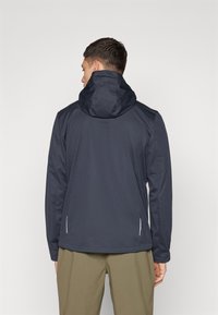 Navy blue hooded jacket with a smooth texture, featuring side slits and white accents. The design is fitted and lightweight.