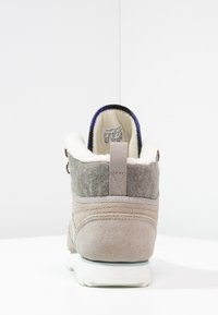 Grey suede ankle boot with a white fuzzy lining, contrasting blue collar, and a textured grey felt back. Includes a tab for easy wearing.