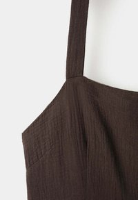 Dark brown textured fabric dress with wide shoulder strap and square neckline, photographed on a plain light background.