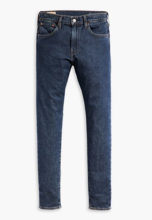 Ciemnoniebieskie jeansy wykonane z denimu o slim fit. Posiadają pięć kieszeni, zapięcie na guzik oraz widoczne szycia wzdłuż brzegów. Prosty krój nogawki.