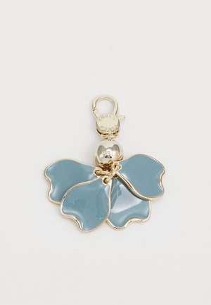 Blue enamel floral keychain with three petal-shaped sections, gold hardware, and a circular charm engraved with "Furla."