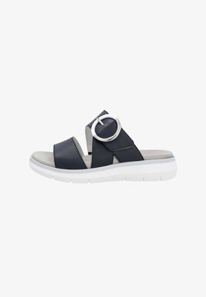 Dark blue leather slide sandal with a circular silver accent, lightweight white sole, open toe, and cushioned footbed.