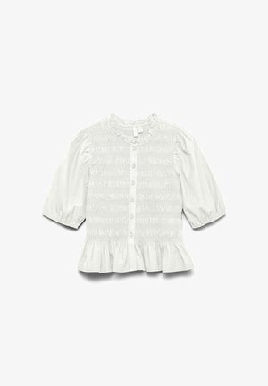 Blusa bianca con maniche a palloncino corte, dettagli arricciati sul davanti, chiusura con bottoni e orlo a ruffles. Realizzata in tessuto leggero.