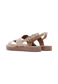 Beige sandals with a textured, croc-embossed design. Features adjustable straps with a metallic buckle and a brown, ridged sole.