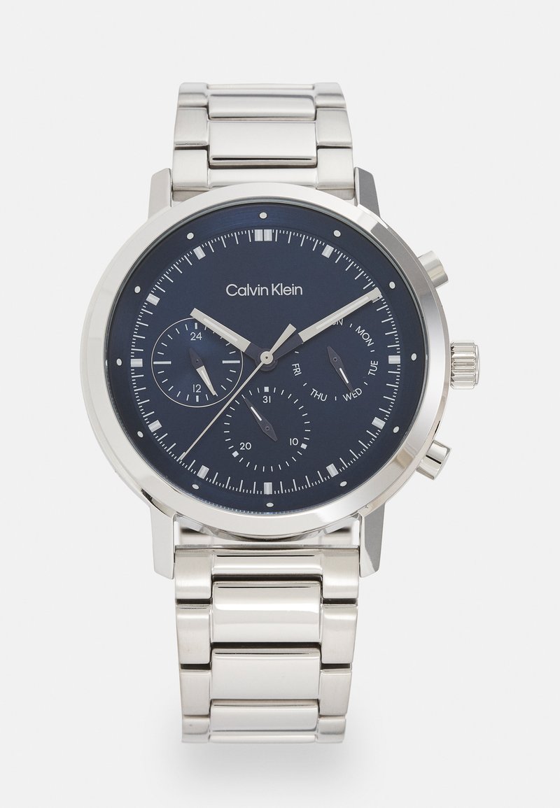 Silver stainless steel watch with a navy blue dial, multifunction sub-dials, silver hands, and a linked metal bracelet.