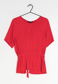 Blusa rossa a maniche corte con scollatura rotonda, vita elastica e dettaglio annodato all'orlo. Tessuto liscio e design a vestibilità rilassata.