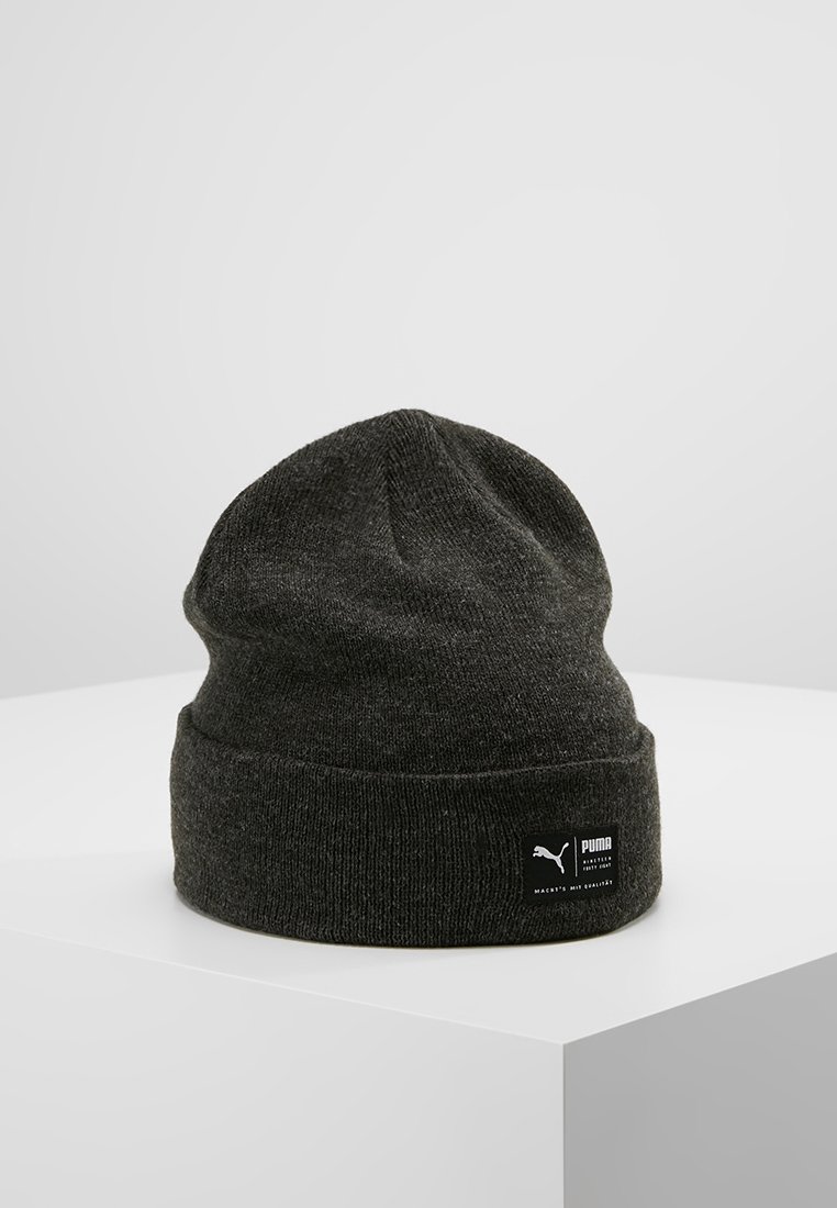 Dark gray beanie hat made of knit material, featuring a folded cuff and a small black brand label on the side. Simple, functional design.