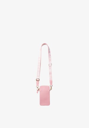 Small rectangular pink crossbody bag with adjustable strap featuring the word "SPIRIT" in light pink and shiny gold hardware.
