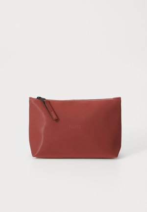 Red waterproof pouch with smooth texture, zip closure, and embossed logo. Rectangular shape with rounded edges. Measures approximately 25 cm wide.