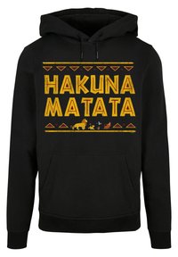 Svart bomullshuvtröja med "HAKUNA MATATA" i stora gula bokstäver. Har djurgrafik och dekorativa röda triangulära mönster. Framficka.