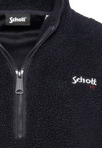 Pullover in pile nero con collo con cerniera, logo Schott sul petto e superficie testurizzata per il calore.