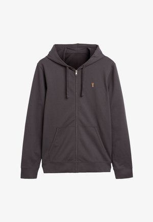 Felpa grigia con zip, realizzata in tessuto morbido. Presenta una tasca a marsupio frontale, un cappuccio con cordino e un piccolo logo sul petto sinistro.