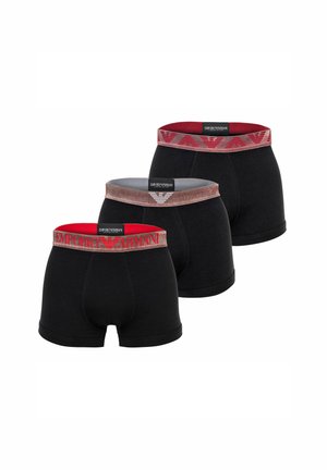 Tre boxer da uomo neri con elastici rossi e grigi con marchio Emporio Armani disposti in fila sfalsata.