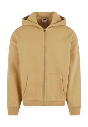 Zip-front hoodie in a light tan color, featuring a hood, two front pockets, ribbed cuffs, and a soft texture.