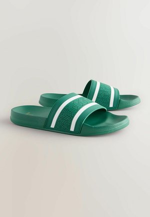 Gröna halkskyddsandaler i texturerad gummi, med två vita randiga detaljer på en bred rem och en mönstrad fotbädd.