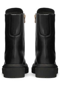 Botas de cuero negras hasta el tobillo con un acabado suave, que presentan cremalleras laterales y una suela gruesa y texturizada para mayor estabilidad.
