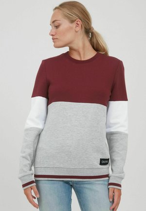 Bordeaux en grijze sweatshirt met witte mouwen, geribbelde textuur, ronde hals en een klein logo-label op de onderste rand. Heeft contrasterende boorden.