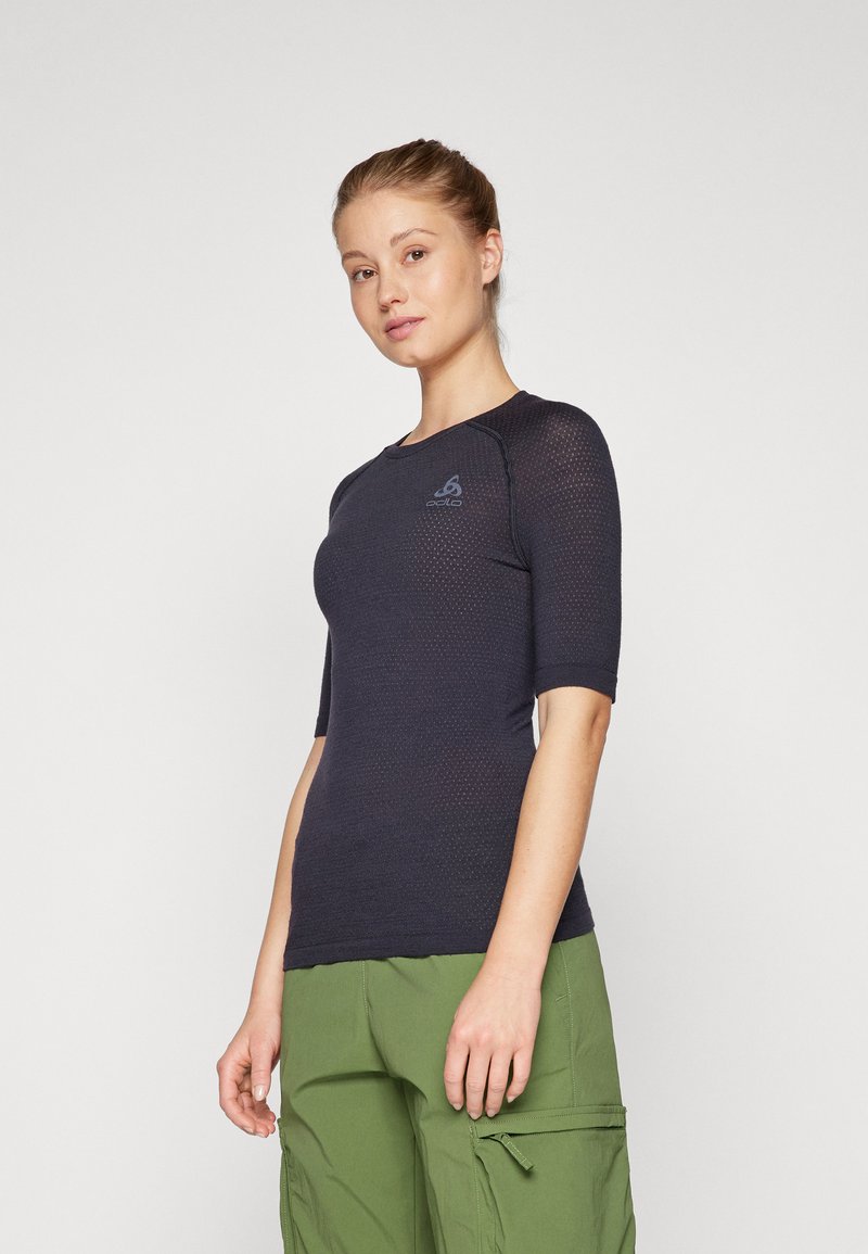 Dark blue, fitted short-sleeve athletic shirt with textured fabric and a round neckline. Features a logo detail on the chest.
