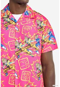 Short-sleeve shirt in vibrant pink fabric featuring a bold graphic print of characters surrounded by yellow flames and text elements.