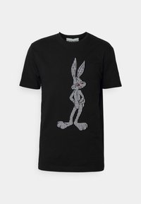 Black short-sleeve t-shirt featuring a white houndstooth pattern rabbit graphic with red accent details, made from cotton material.