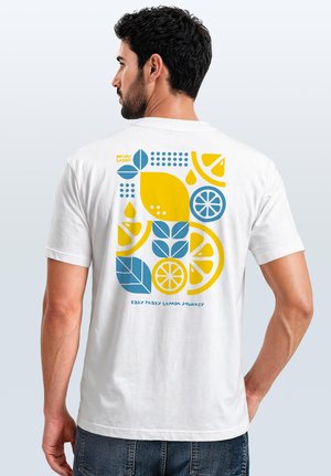 Man in a white T-shirt with colorful blue and yellow lemon, leaf, and geometric shapes design on the back, text reads "Easy Peasy Lemon Squeezy."