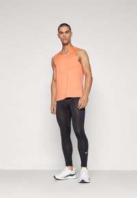 Nike Performance RISE TANK - Top - light wild mango/reflective silver