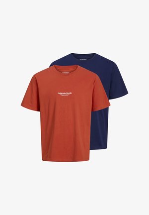 Two crew-neck t-shirts: one in rust orange with white text "Originals Studio," and one in navy blue, both made from soft cotton fabric.